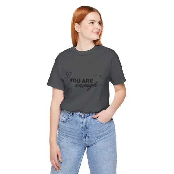Woman in "You Are Enough" t-shirt smiling.