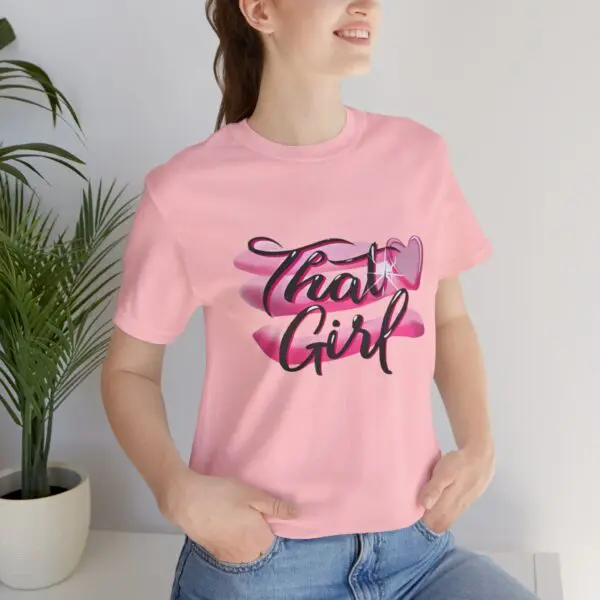 Woman wearing pink "That Girl" t-shirt.