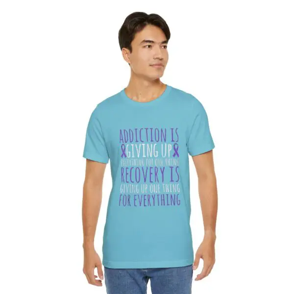 Man wearing recovery-themed blue t-shirt.