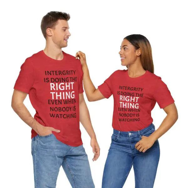 Two people wearing matching red t-shirts.