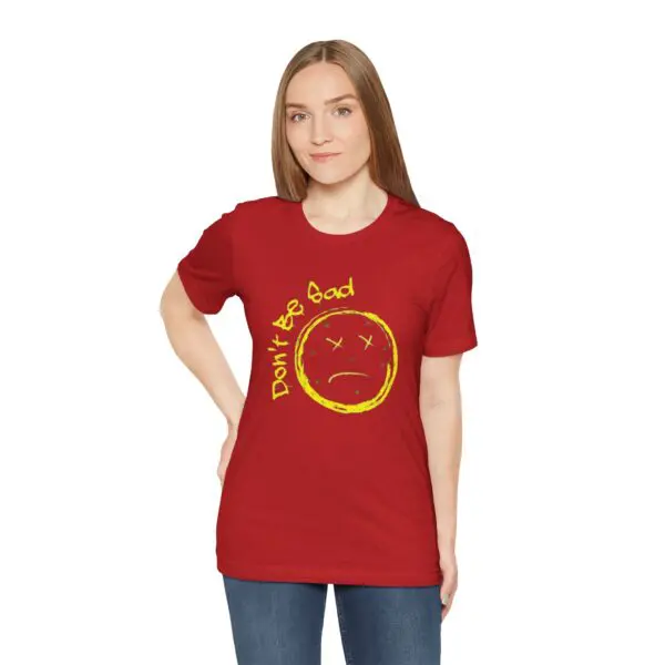 Woman wearing red "Don't Be Sad" shirt.