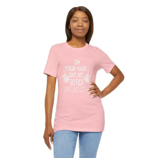 Woman wearing pink graphic t-shirt, smiling.