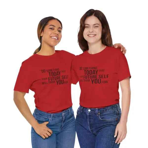 Two women wearing matching red shirts.