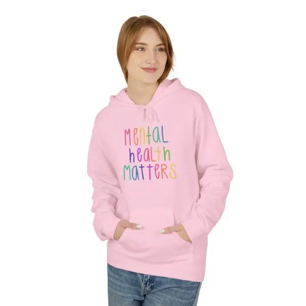 Person wearing "Mental Health Matters" pink hoodie.