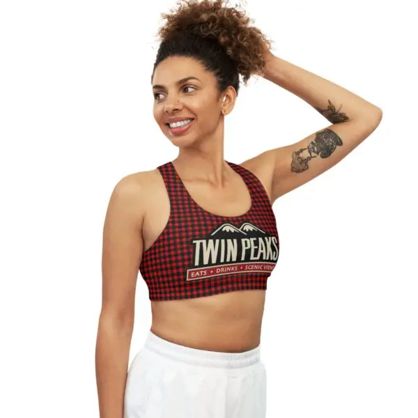 Smiling woman in checkered sports top.
