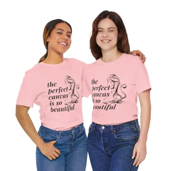 Two women wearing matching pink shirts.
