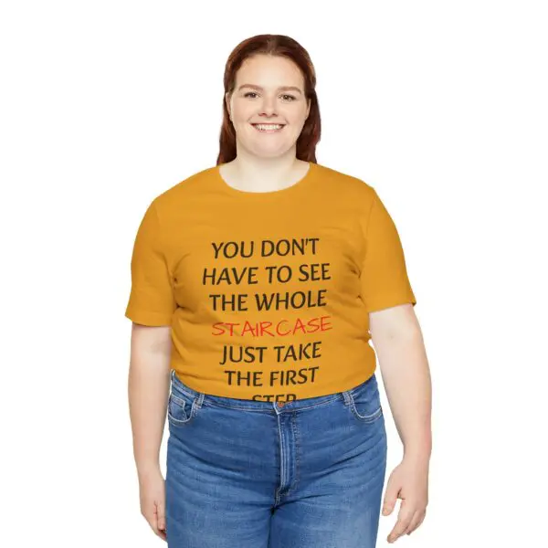 Smiling woman wearing motivational quote t-shirt.