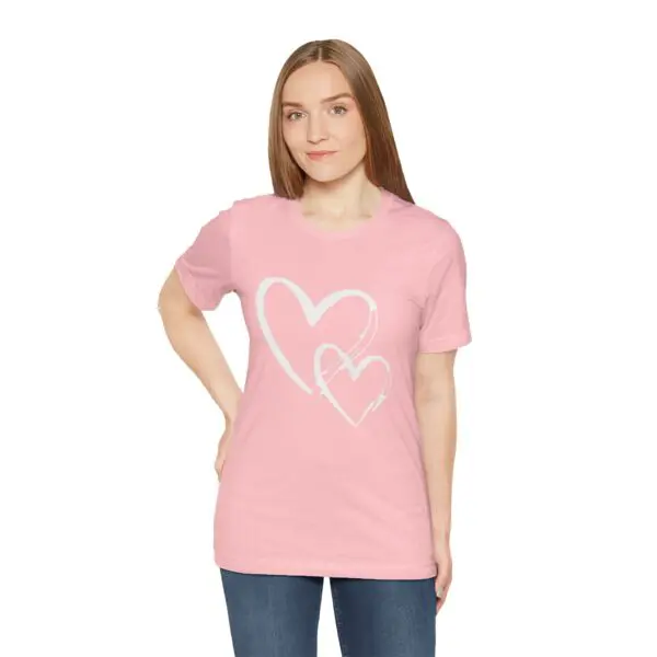 Woman wearing pink heart-design t-shirt.