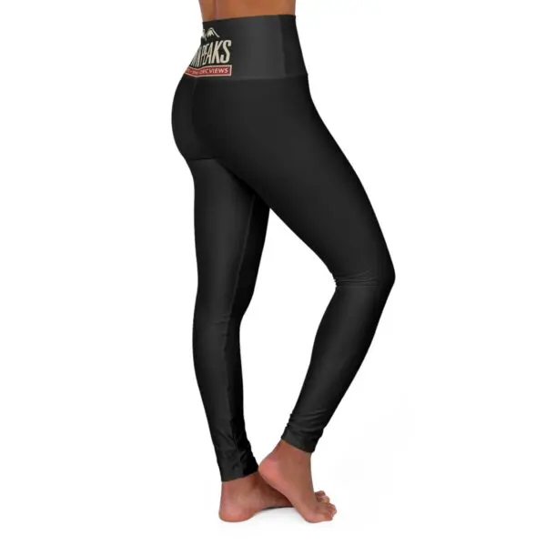 Woman wearing black high-waisted leggings standing.