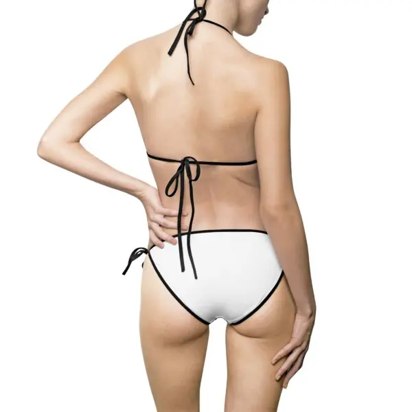 Woman in white bikini, back view.