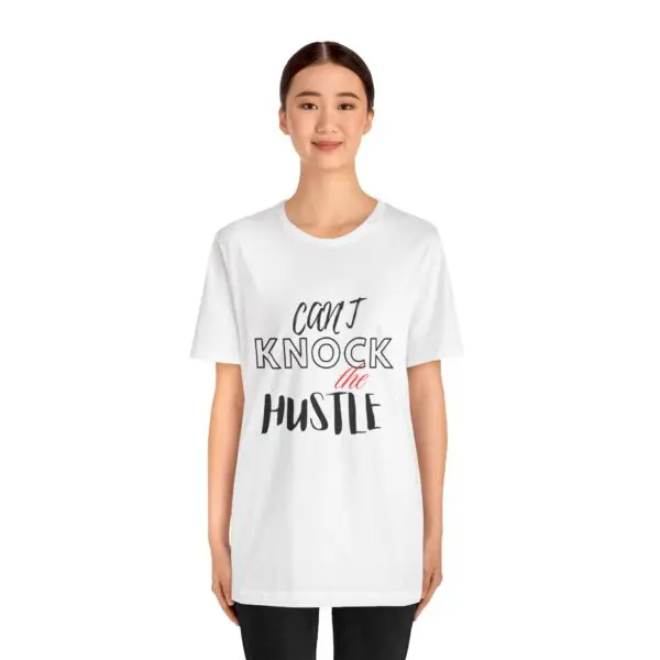 Person wearing "Don't Knock the Hustle" shirt.