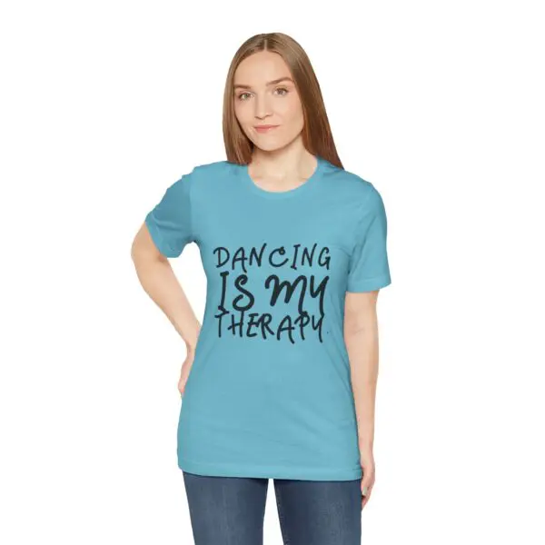 Woman in blue shirt with dance slogan.