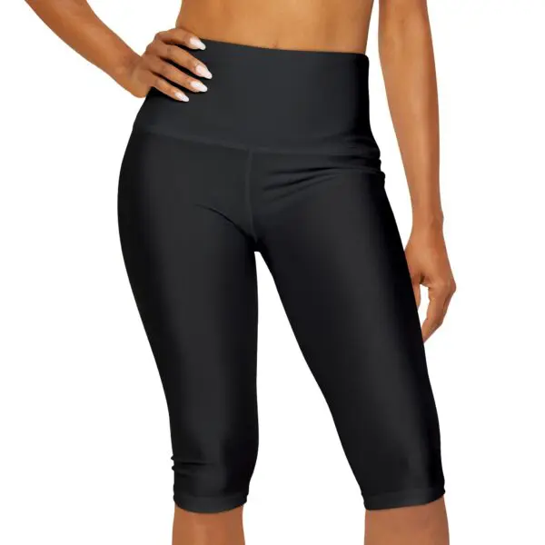 Woman modeling black high-waisted athletic leggings.