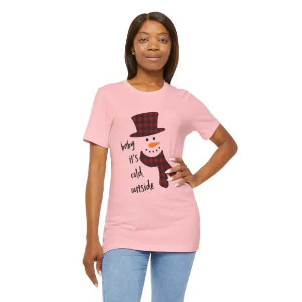 Woman wearing pink snowman graphic t-shirt.