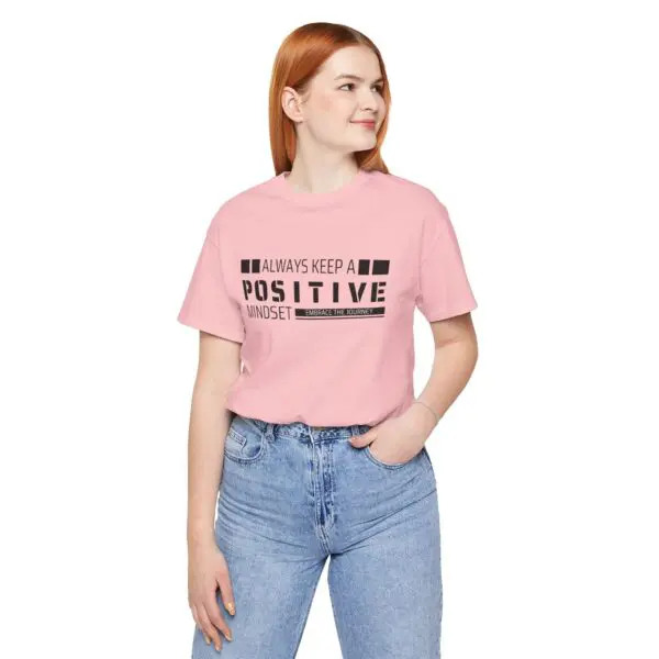 Woman in pink shirt with positive message.
