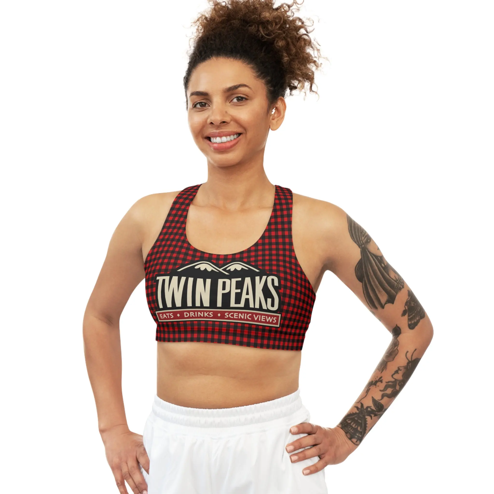 Smiling woman in Twin Peaks sports top.
