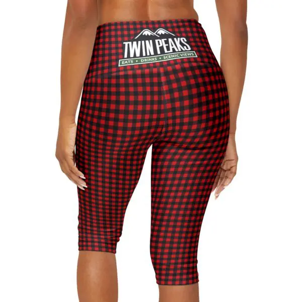 Woman wearing red checkered leggings.