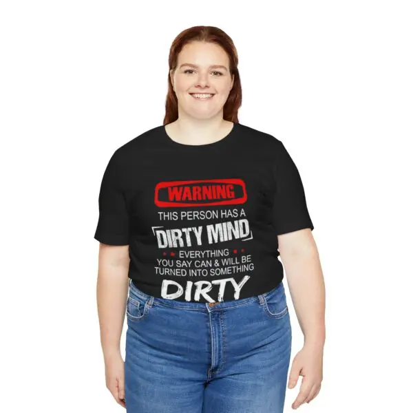 Smiling person wearing graphic T-shirt.