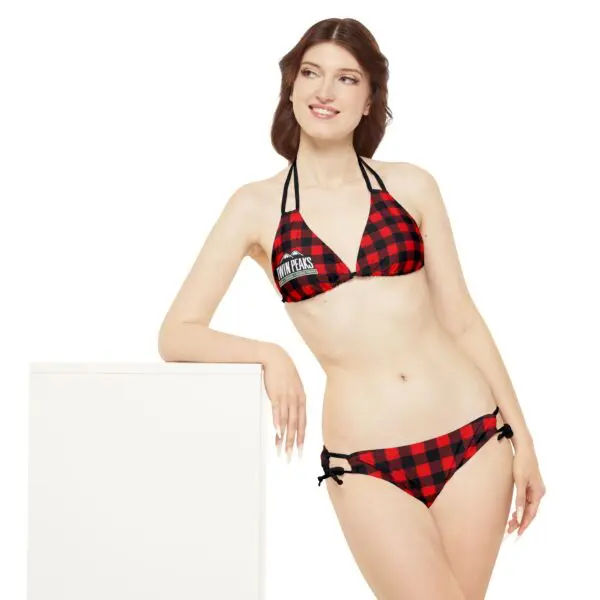 Woman in red checkered bikini smiling.