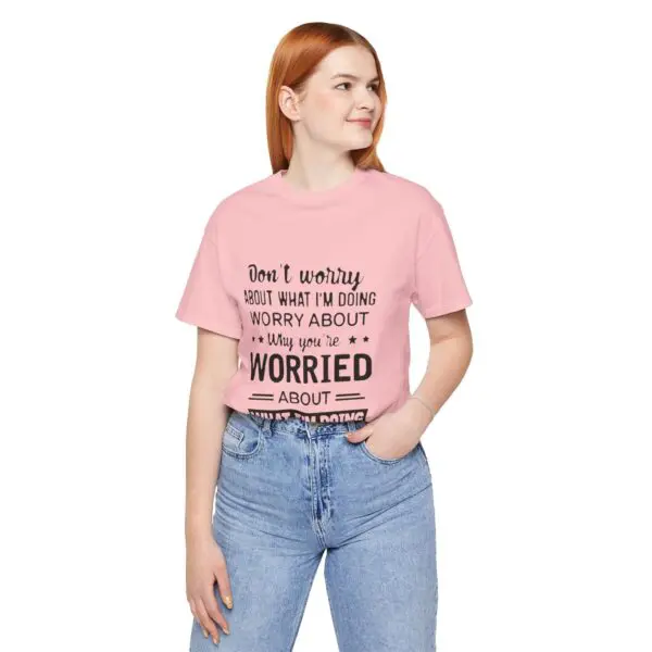 Woman in pink shirt with printed text.