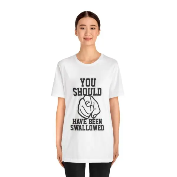 Person wearing a T-shirt with bold text.