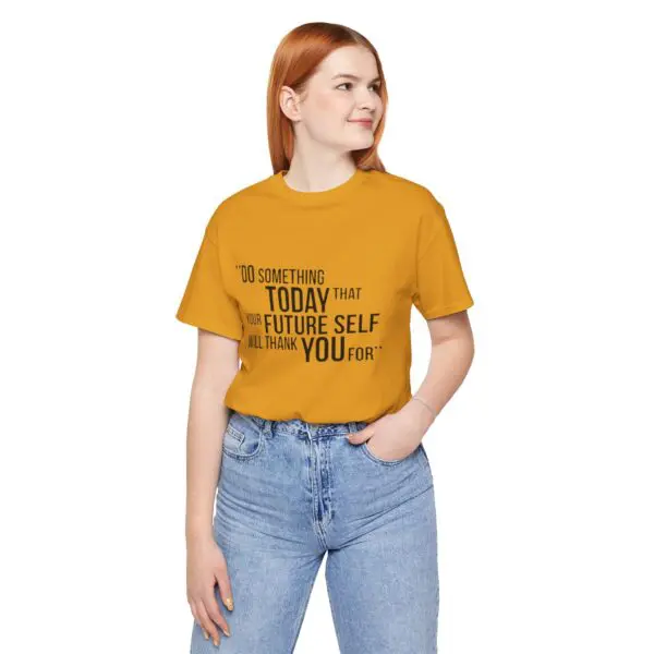 Woman wearing mustard motivational t-shirt, smiling.