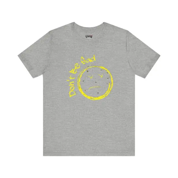 Gray T-shirt with yellow sad face.