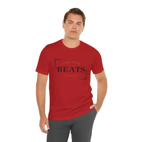 Man in red "Beats" t-shirt standing.