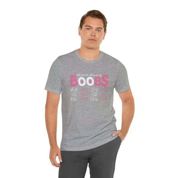 Man wearing gray graphic t-shirt, neutral pose.