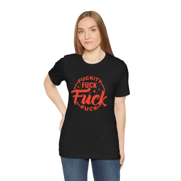 Woman wearing black graphic t-shirt, hands on hips.
