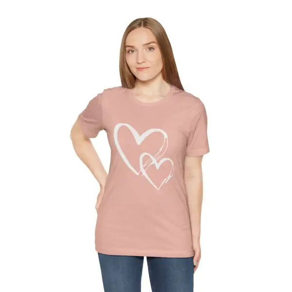 Woman wearing pink heart-patterned t-shirt.
