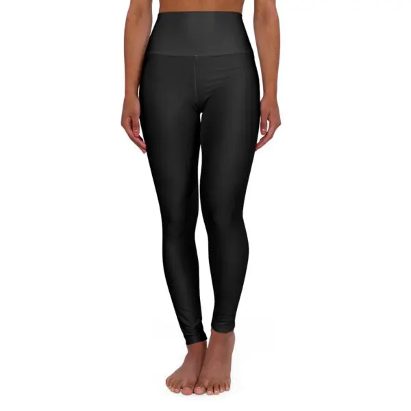 Woman wearing black high-waisted leggings.