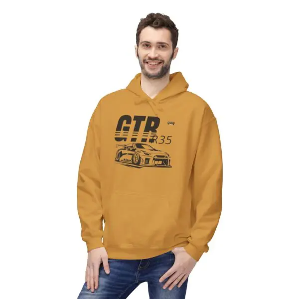 Man wearing mustard GTR hoodie, smiling.