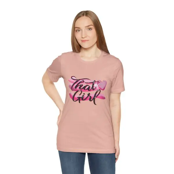Woman wearing pink "That Girl" t-shirt.