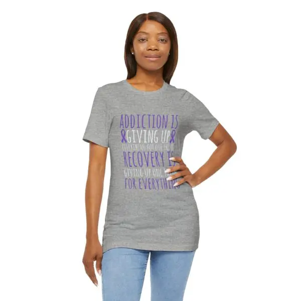 Woman wearing grey motivational t-shirt.