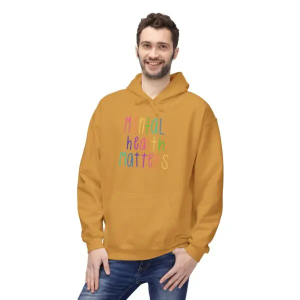 Smiling person in "Mental Health Matters" hoodie.